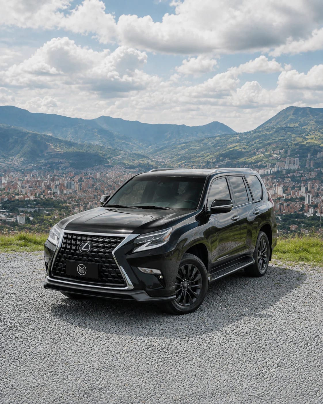 Front of the black Lexus GX: mesh grille, headlights and darkened bumper.